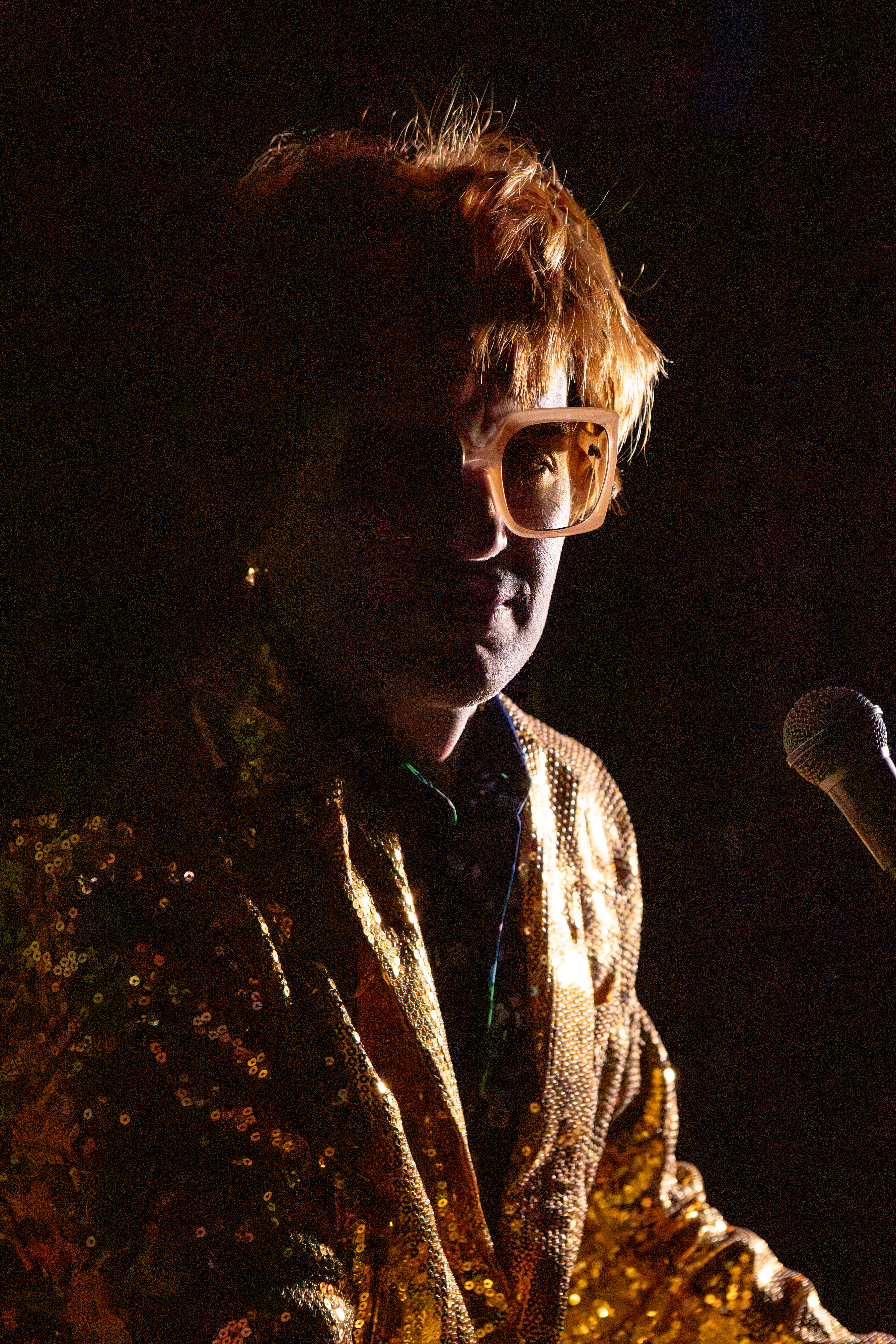 Michael Turner on stage in costume as early 1970s Elton John